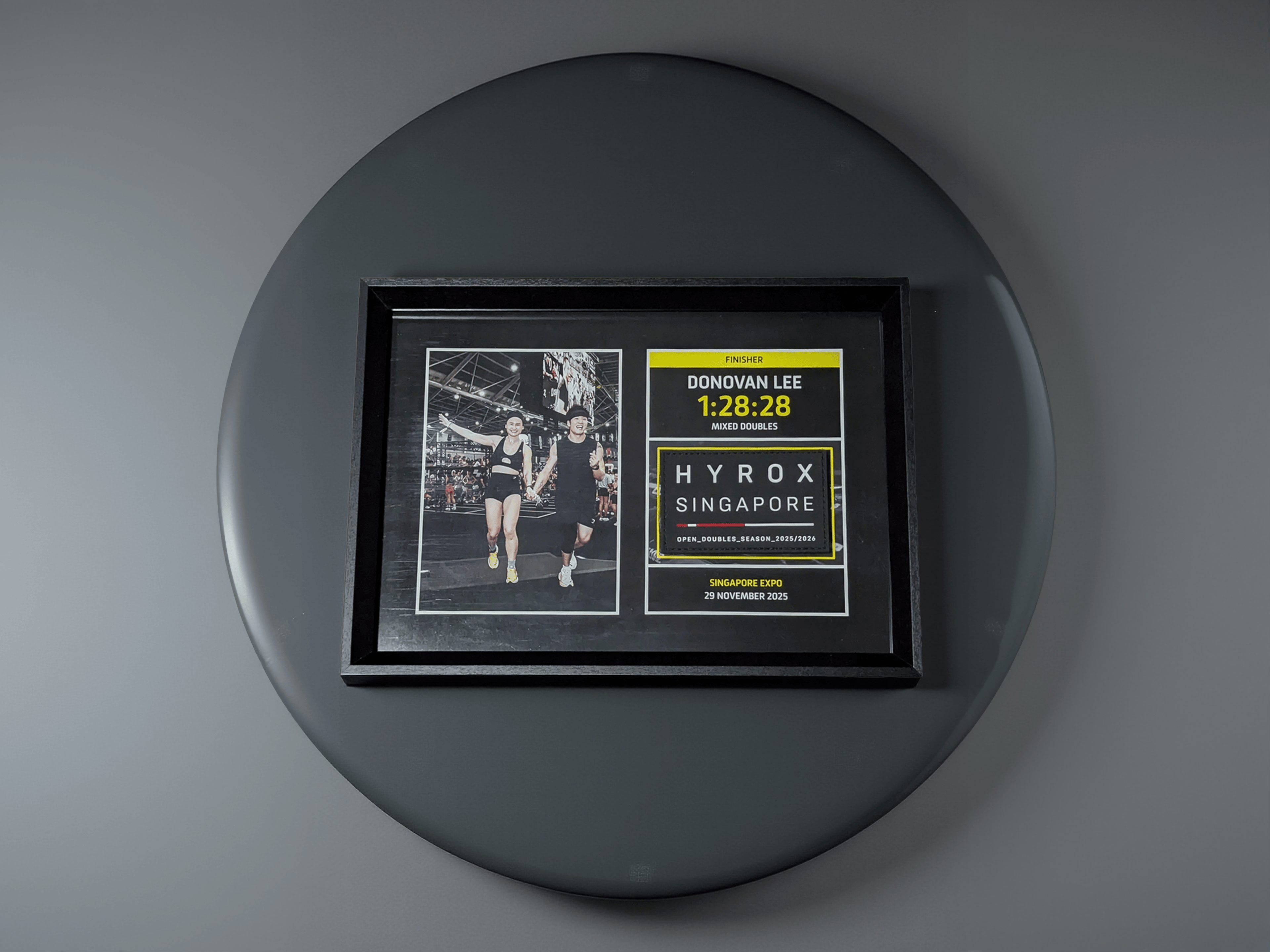 Finisher Frame featuring a Mixed Doubles team finishing a HYROX race at the Singapore Expo in 2025